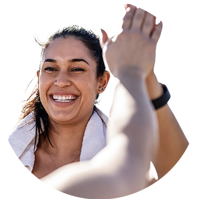 A women exercising with a gym towel and giving a high five