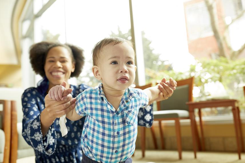 Parent and baby smiling in doctor office waiting room