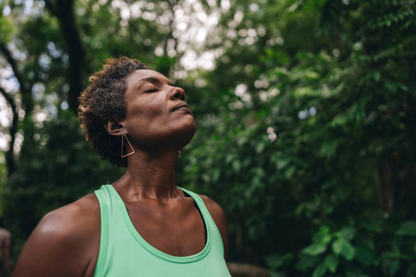 Woman outside taking a deep breath