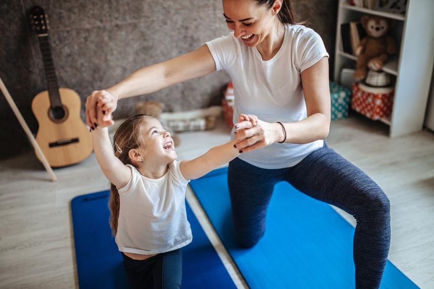 Mother and daughter doing yoga together