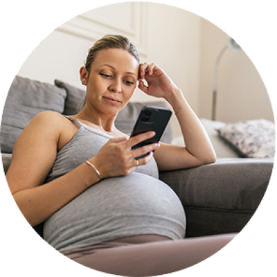 An expecting person looking at their phone