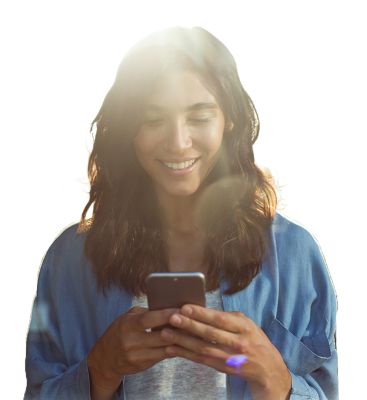 A smiling women looking at her phone. 