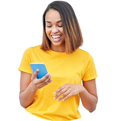 A smiling women looking at her phone