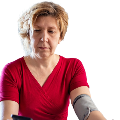 A women in a red shirt checking her own blood pressure. 