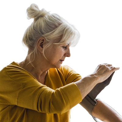 A women putting a blood pressures testing cuff around her upper arm. 