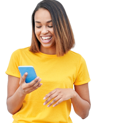 A smiling women looking at her phone. She is wearing a very bright yellow shirt. 