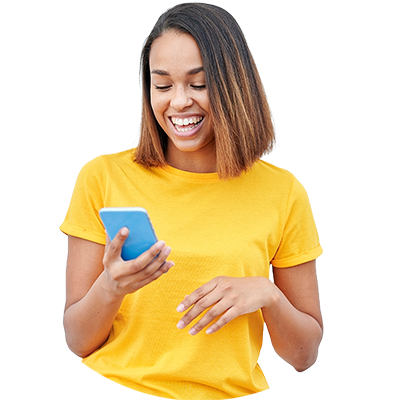 A smiling women looking at her phone