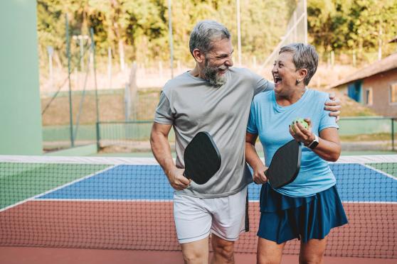 Senior couple playing pickleball 