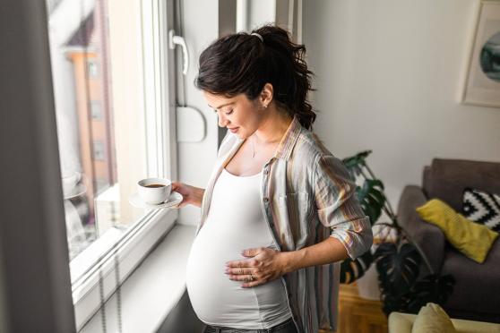 Woman holding her pregnant stomach
