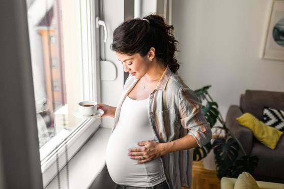 Woman holding her pregnant stomach